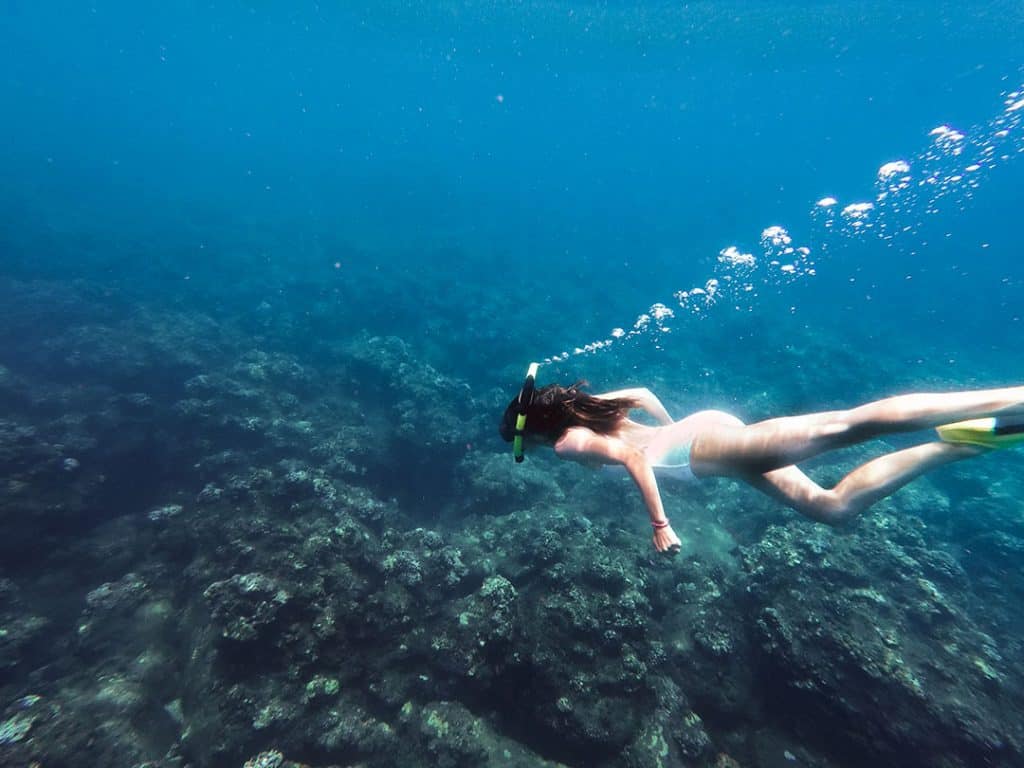 Swimming along coral reefs on Kauai's Na Pali Coast