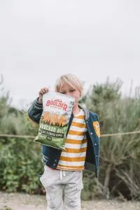 Child holding Boulder Canyon Potato Chips