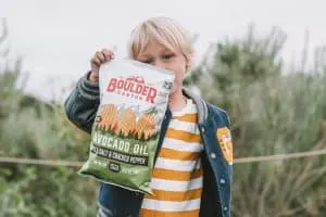 Child holding Boulder Canyon Potato Chips
