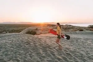 Walking back up the dunes to go sanboarding