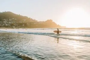 Surfer walking out of the water at Pacifica State Beach