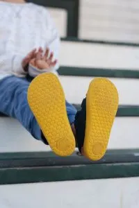 The soles of barefoot shoes for kids are foot shaped and flexible