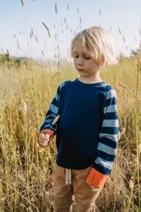 Hudson wearing a long-sleeve merino wool shirt for kids