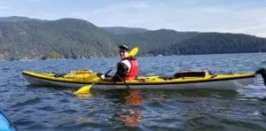 Derek of Floating Authority kayaking on a lake