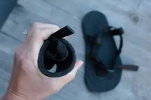 Unshoes sandals for kids rolled up to test sole flexibility