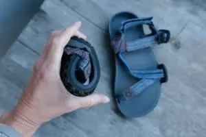 Xero Shoes sandals for kids rolled up to test sole flexibility